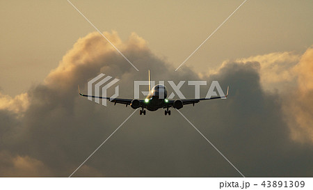 High contrast of jet plane landing against clouds 43891309