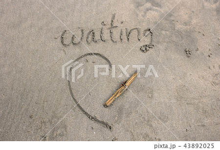 The waiting word on sand beach 43892025