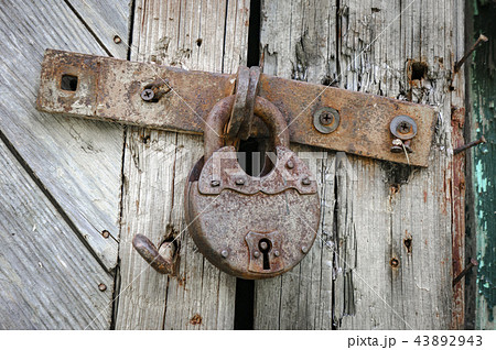 Old lock on the door. lock on the door of an old farmhouse . true village style Old lock on the door. lock on the door of an old farmhouse . true village style 43892943