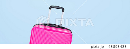 banner pink suitcase isolated on blue background 43893423