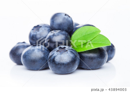 Fresh raw organic blueberries with leaf on white Fresh raw organic blueberries with leaf on white 43894003