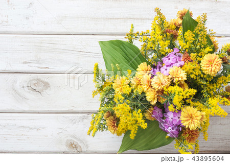 Autumn bouquet of yellow wildflower on white board 43895604