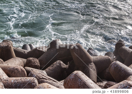 Stones are concrete constructions of the quay of breakers of breakwaters. Close. 43899806