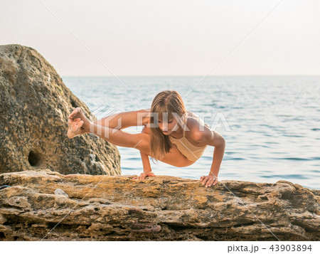 young woman in swimsuit practicing yoga at amazing sunrise. Fitness, sport, yoga and healthy young woman in swimsuit practicing yoga at amazing sunrise. Fitness, sport, yoga and healthy 43903894