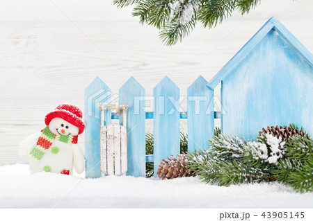 Christmas snowman and sledge toys and fir tree 43905145