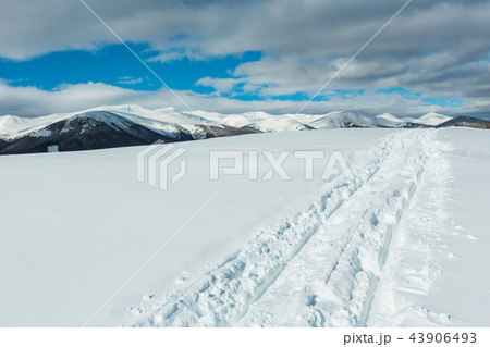 Sledge trace and footprints on winter mountain Sledge trace and footprints on winter mountain 43906493