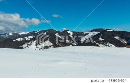 Cross on winter mountain hill top 43906494