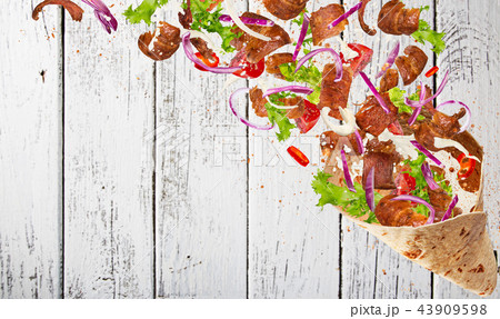 Kebab sandwich with flying ingredients. 43909598