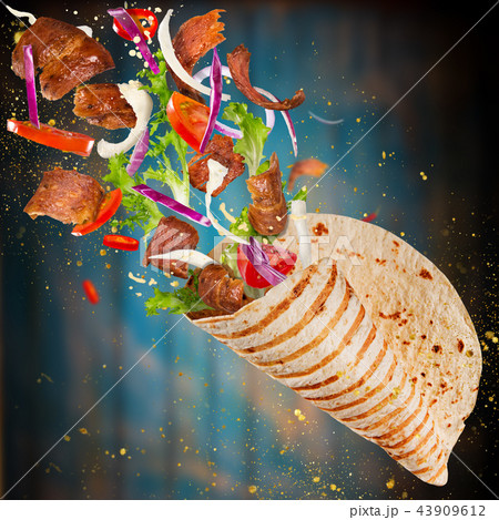 Kebab sandwich with flying ingredients. 43909612