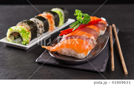 Japanese sushi set on a rustic dark background. Japanese sushi set on a rustic dark background. 43909633