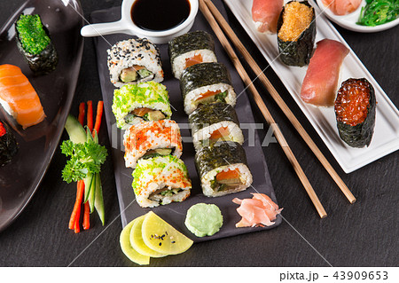 Japanese sushi set on a rustic dark background. Japanese sushi set on a rustic dark background. 43909653