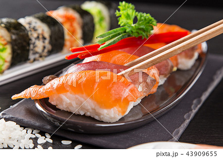 Japanese sushi set on a rustic dark background. Japanese sushi set on a rustic dark background. 43909655