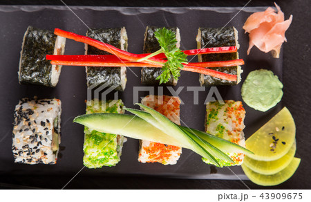 Japanese sushi set on a rustic dark background. Japanese sushi set on a rustic dark background. 43909675