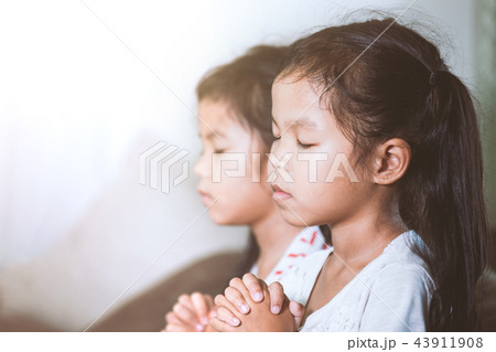 asian girl and sister praying with folded hand asian girl and sister praying with folded hand 43911908
