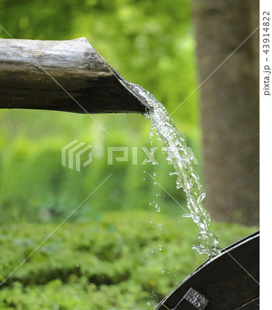 water flows from a wooden pipe or water gushing  43914822