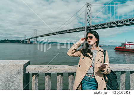 woman holding sunglasses while looking somewhere 43916203