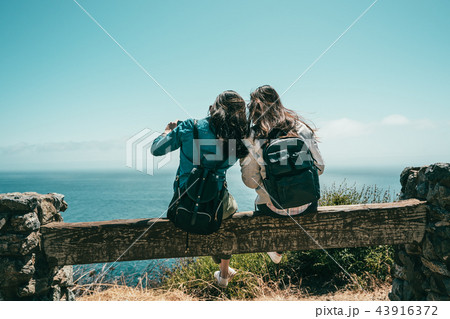 back view of friends sittingon the bench back view of friends sittingon the bench 43916372