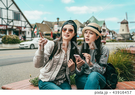 sisters finding something while sitting 43916457