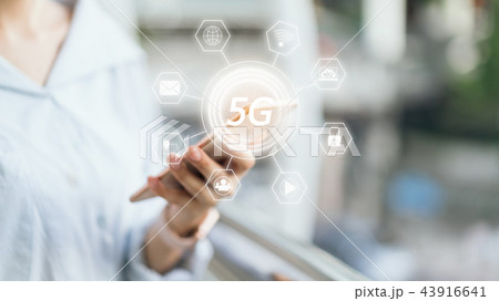 Woman holding smartphone to screen icon 5G. 43916641