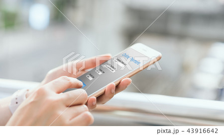 Woman holding smartphone to enter online payment. 43916642