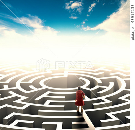 Miniature people standing over a maze.  43917153