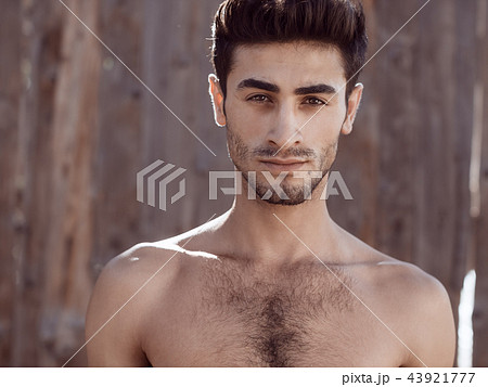 Handsome topless young man outdoors 43921777
