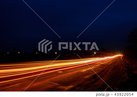 Headlights of cars, taken with long-term exposure to the background of the sky 43922054