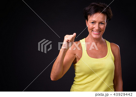 Mature beautiful woman with short hair against black background 43929442