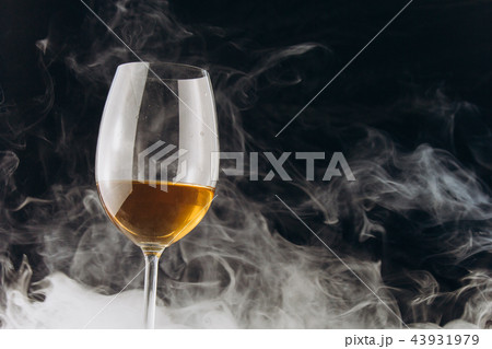 Glass in the smoke on black background 43931979