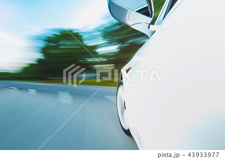 Motion blurred image a luxury vehicle driving Motion blurred image a luxury vehicle driving 43933977