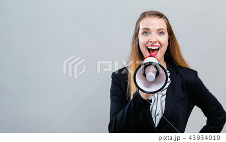 Young woman with a megaphone Young woman with a megaphone 43934010