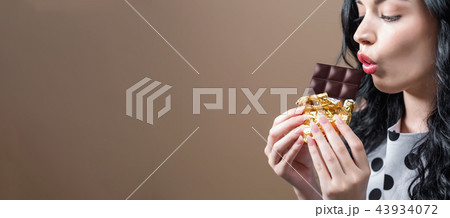 Young woman holding chocolate Young woman holding chocolate 43934072