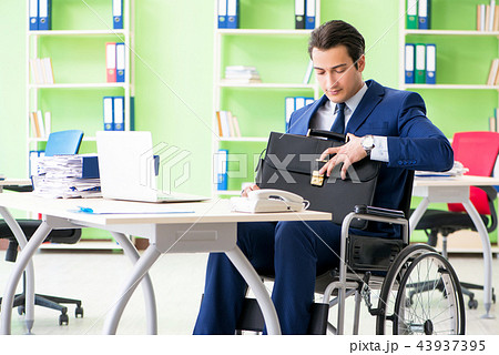 Disabled businessman working in the office Disabled businessman working in the office 43937395