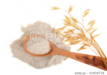 oat spike with flour in wooden spoon isolated on white background. Top view. Flat lay oat spike with flour in wooden spoon isolated on white background. Top view. Flat lay 43938738