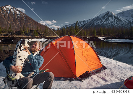 Man playing with his dog at outdoors camping 43940348