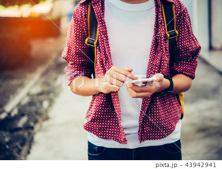 Traveler using smartphone for data connection  43942941