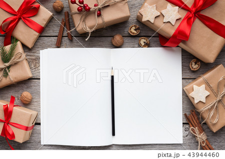 Boxes with gifts and notebook on white table 43944460