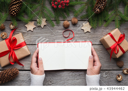Girl reading blank book during christmas holidays 43944462
