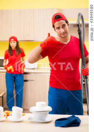Cleaning professional contractors working at kitchen 43949580