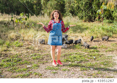 Happy young woman with little wild boars on background. Happy young woman with little wild boars on background. 43951267