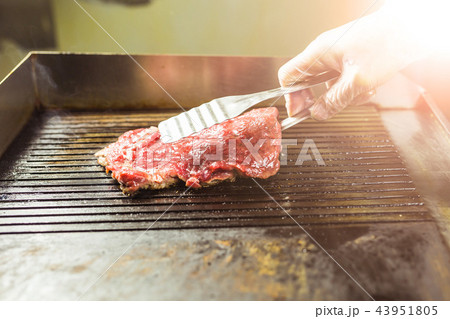 Food and cooking concept - Close up of a steak on grill 43951805