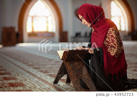 Young praying woman falling on knees in mosque 43952723