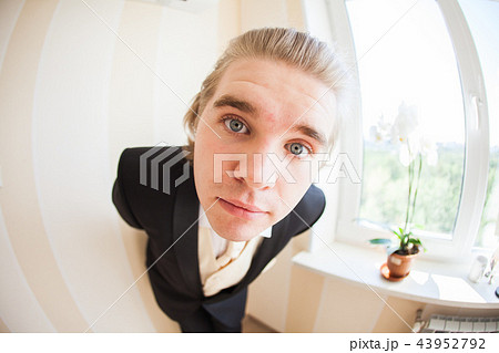 April fools day concept - Portrait of a cheerful funny man smiling at camera 43952792
