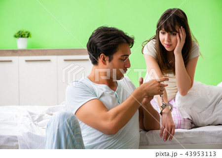 Man suggesting wife to play sexual games with cuffs Man suggesting wife to play sexual games with cuffs 43953113