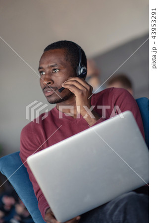 Customer Service agent in an startup office with laptop Customer Service agent in an startup office with laptop 43953291