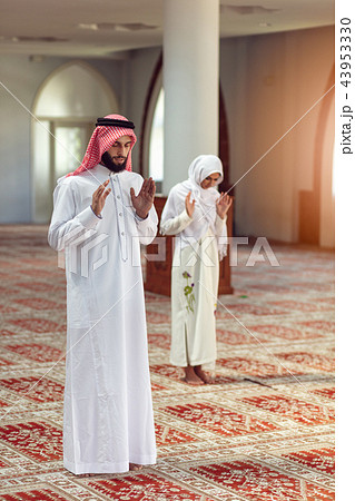 Muslim Praying man and woman in mosque Muslim Praying man and woman in mosque 43953330