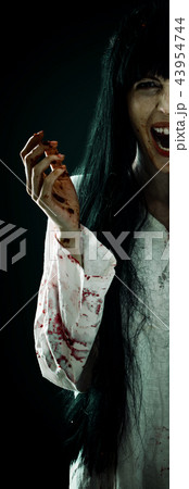 Crazy bloody scary zombie woman screams at camera 43954744