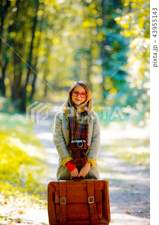 girl with suicase in a park girl with suicase in a park 43955143