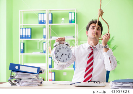 Despaired businessman thinking of suicide in the office Despaired businessman thinking of suicide in the office 43957328