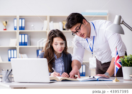 Teacher explaining to student at language training Teacher explaining to student at language training 43957395